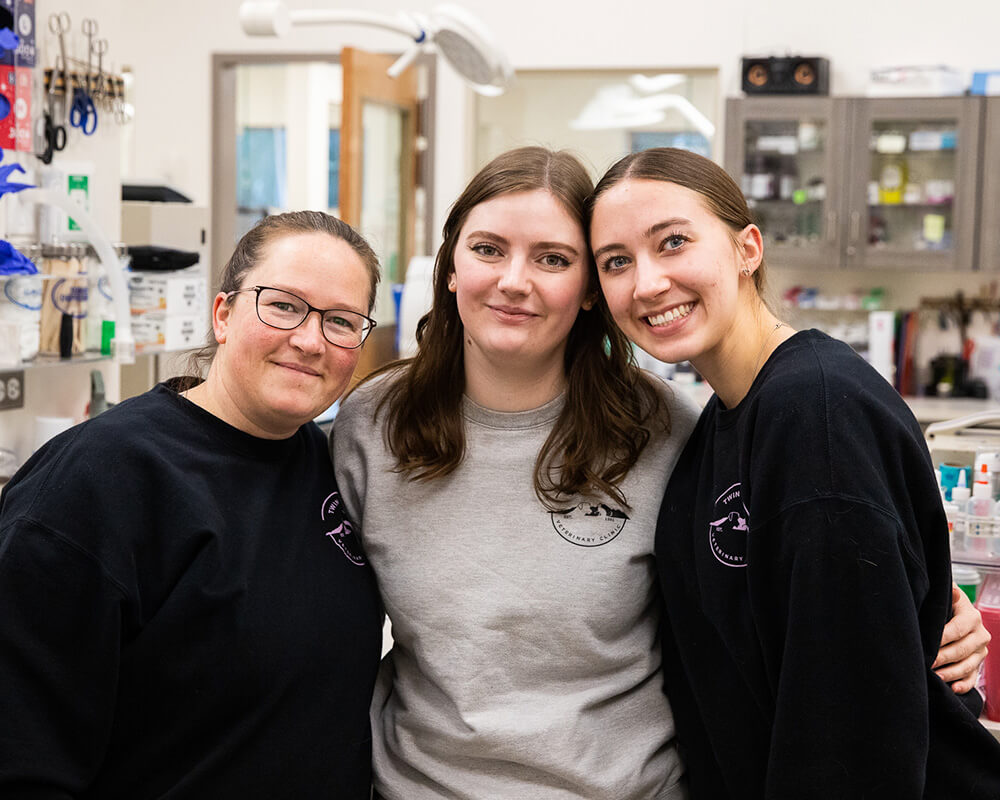 Veterinary staff members posing together inside Twin Cities Veterinary Clinic