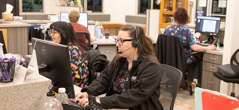 Veterinary team members speaking together inside Twin Cities Veterinary Clinic in Soldotna, Alaska
